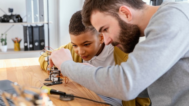 Father and son making robot