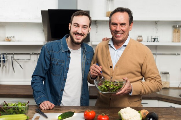 Father and son making salad