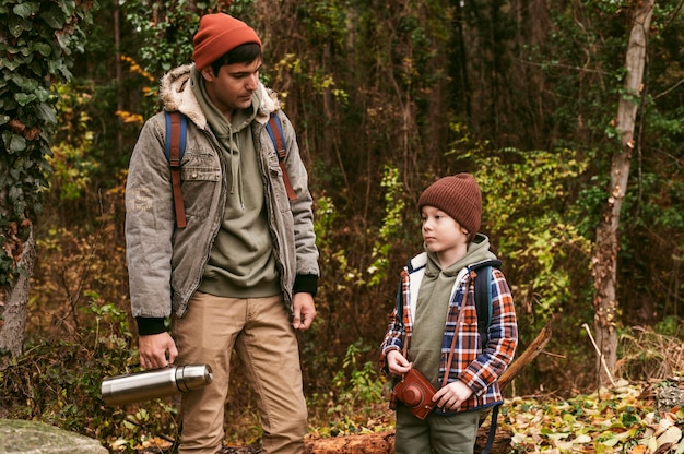 Free photo father and son outdoors on a road trip in nature