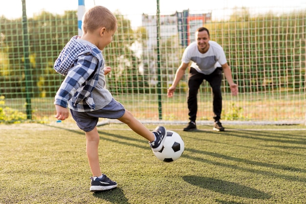 Father and son playing football