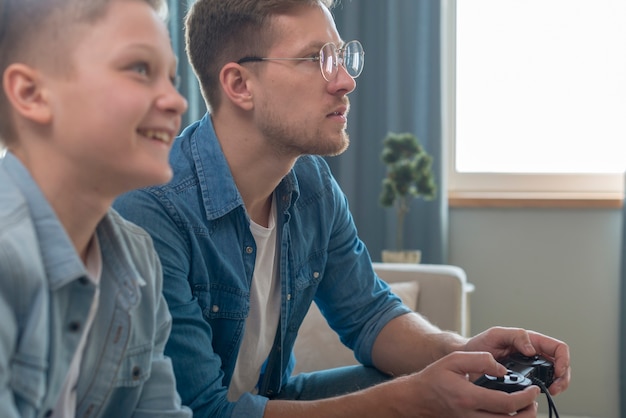 Father and son playing  local games on console