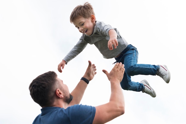 Father and son playing low view