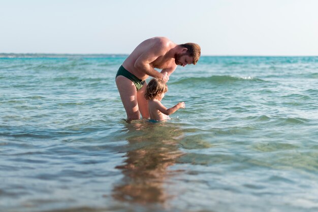 Father and son playing in the ocean