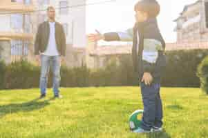 Free photo father and son playing outside