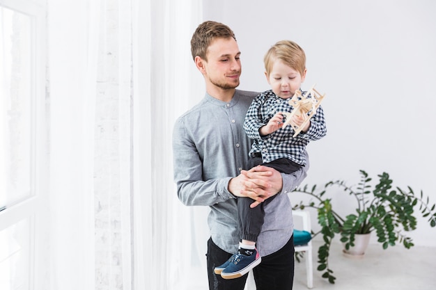 Free photo father and son playing together on fathers day