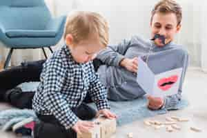 Free photo father and son playing together on fathers day