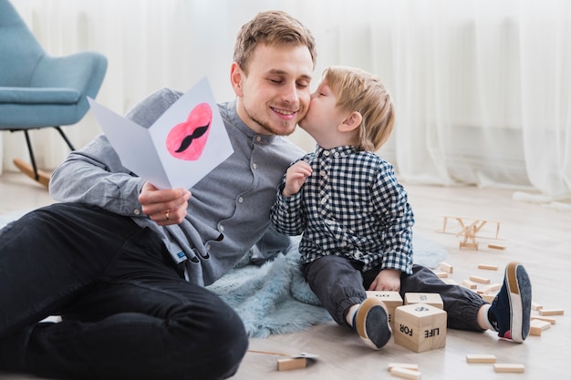 Free Photo father and son playing together on fathers day