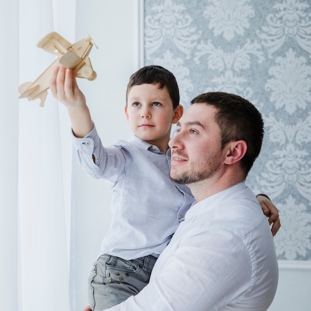 Free photo father and son playing together on fathers day