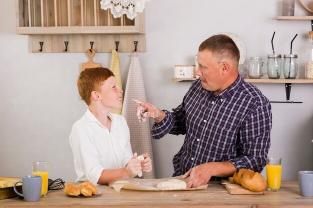 Father and son posing in the kitchen