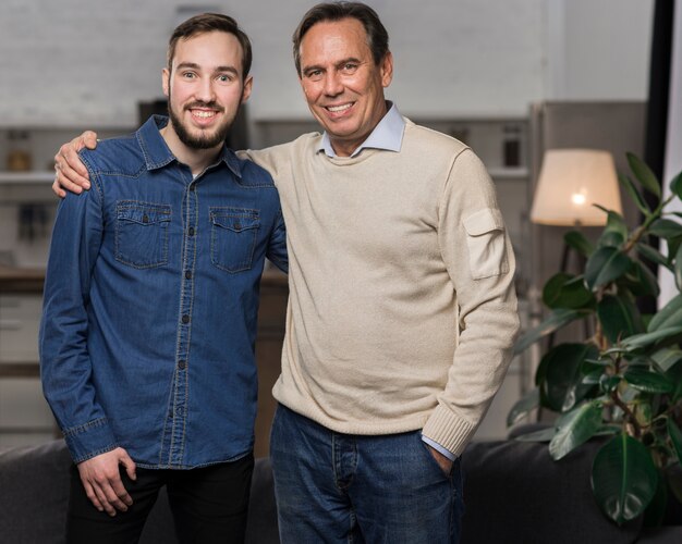 Father and son standing and posin in living room