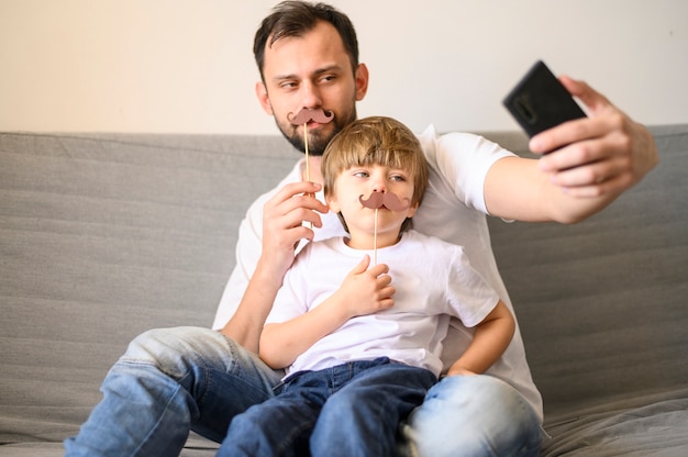 Father and son taking selfie