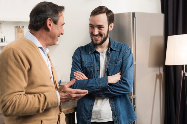 Father and son talking in kitchen