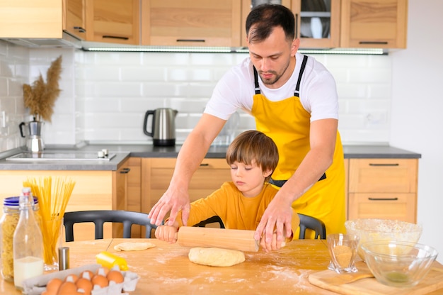 Father and son using the paddle in the kitchen