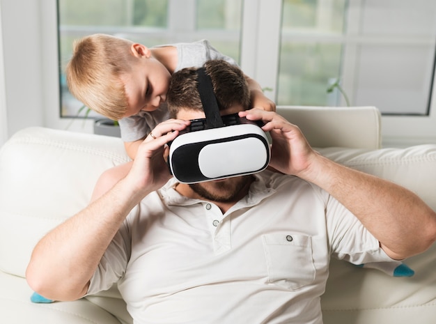 Free photo father and son using virtual headset