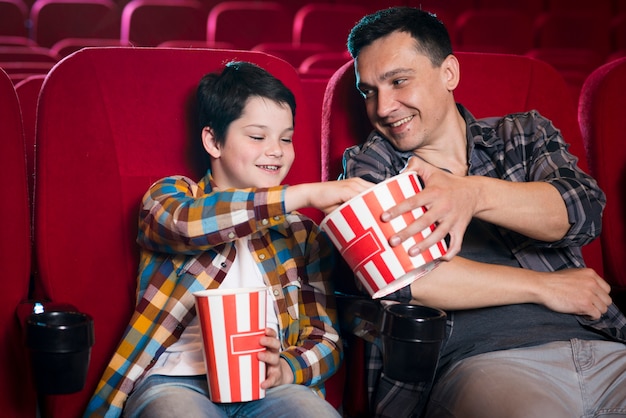 Father and son watching movie in cinema