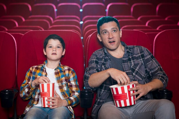 Father and son watching movie in cinema