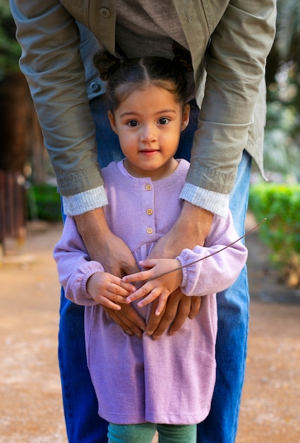 Free photo father spending time with his daughter outdoors on father's day