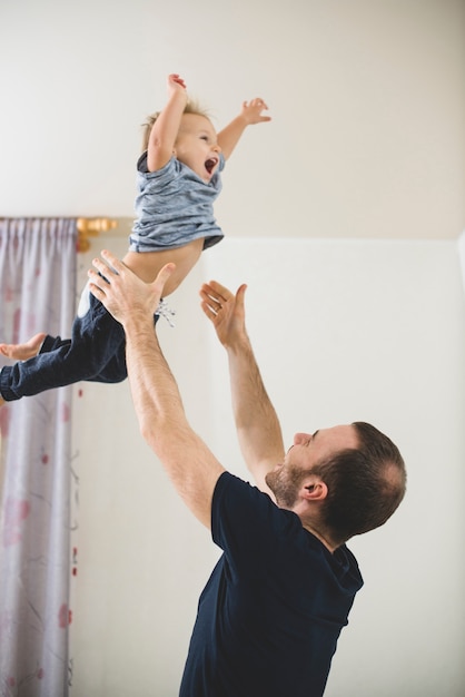 Father throwing his son