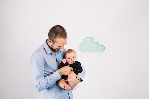 Father tickling baby