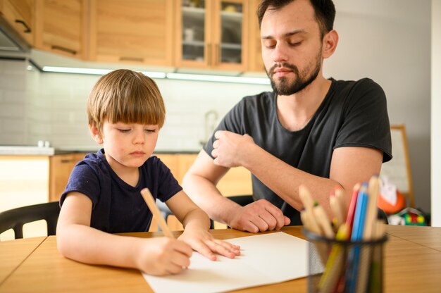 Father watching son draw