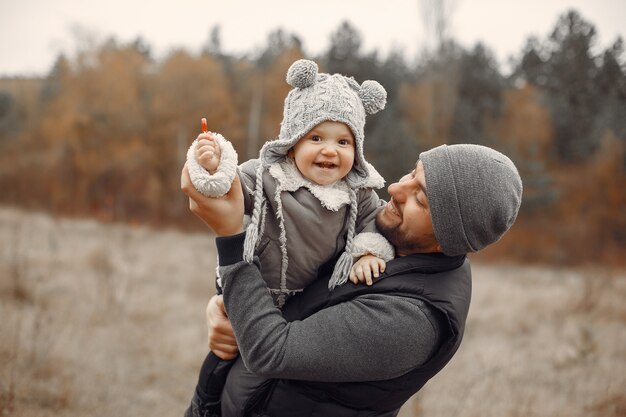 Father with little daughter playing in a spring field