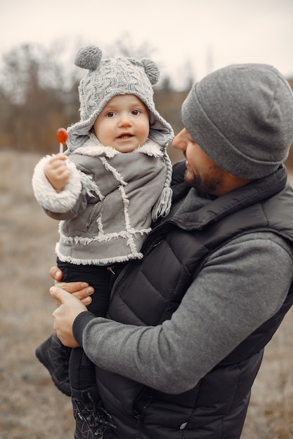 Father with little daughter playing in a spring field