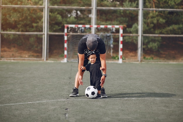 Free Photo father with little son playing football