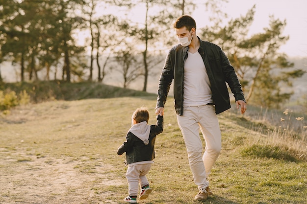 Free photo father with little son wearing masks