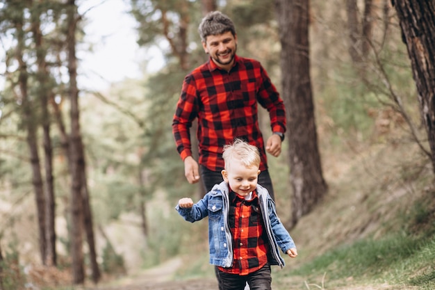 Free photo father with little son in the woods