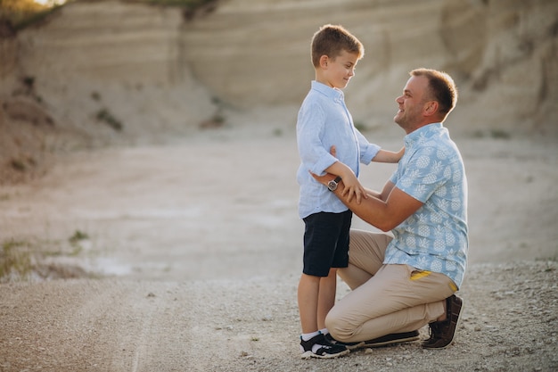 Free photo father with son in sand quarry