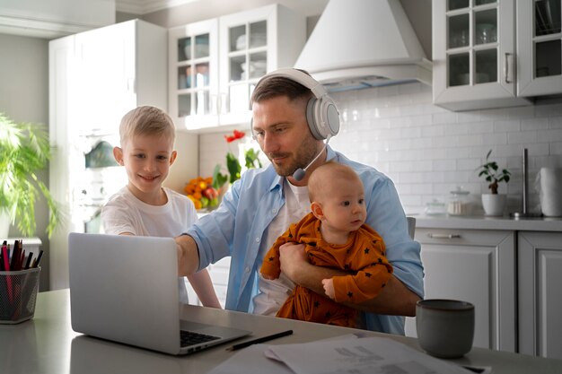 Father working from home trying to balance family life with child and job