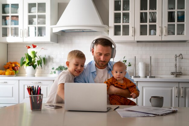 Father working from home trying to balance family life with child and job