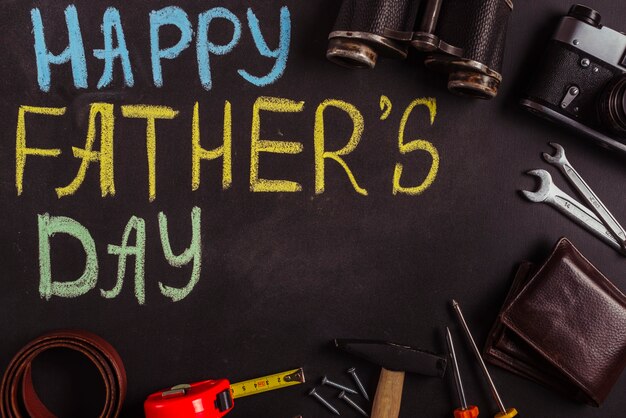 Fathers day composition on blackboard with tools