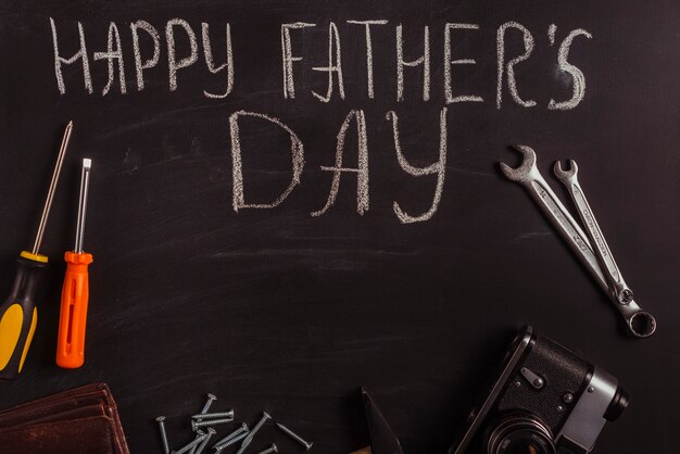 Free photo fathers day composition on blackboard with tools