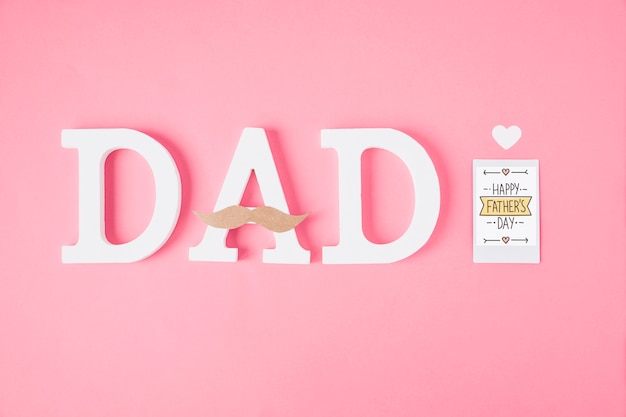 Fathers day composition with letters on pink background