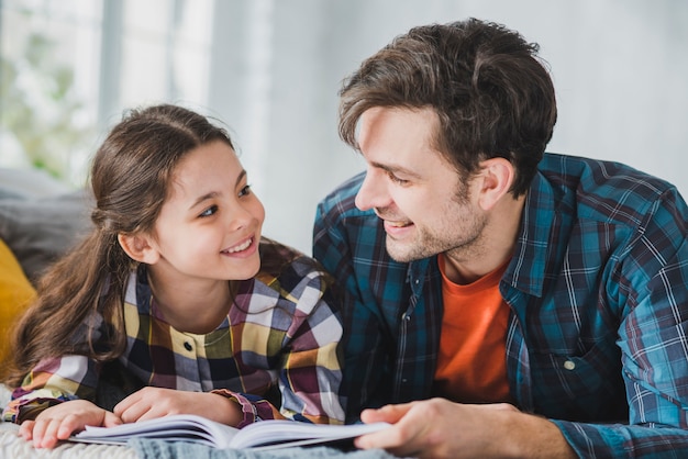 Fathers day concept with father and daughter reading