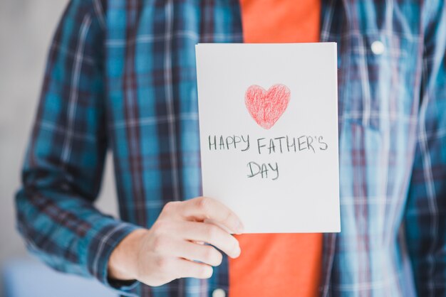 Fathers day concept with father holding hand drawn card