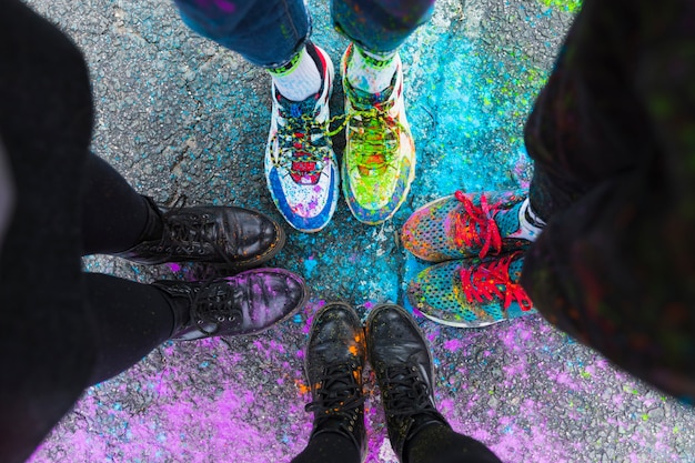 Feet of people standing on road in colorful paint