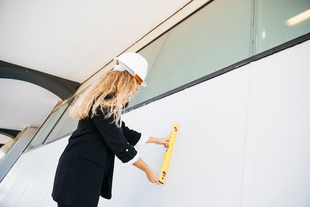 Free Photo female architect on construction site checking wall