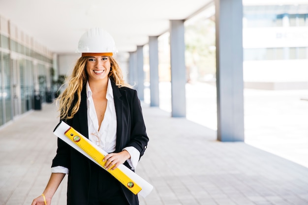 Free Photo female architect with helmet and level