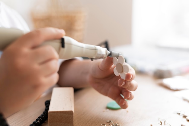 Free Photo female artisan working in the atelier with glue gun