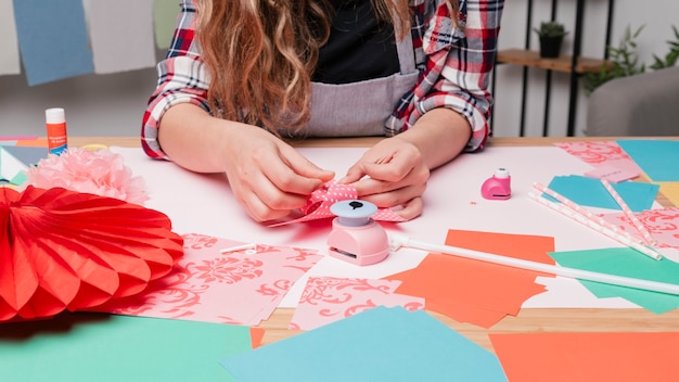 Free photo female artist hand making pinwheel using origami paper