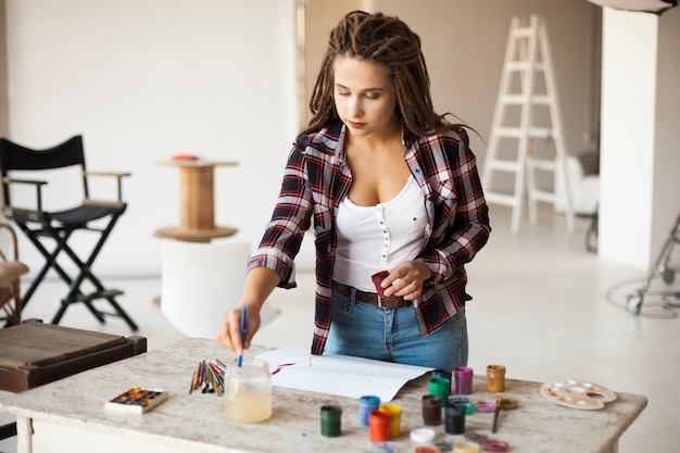 Free photo female artist painting indoors