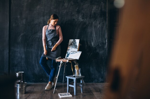 Female artist painting in studio