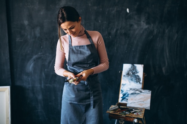 Female artist painting in studio