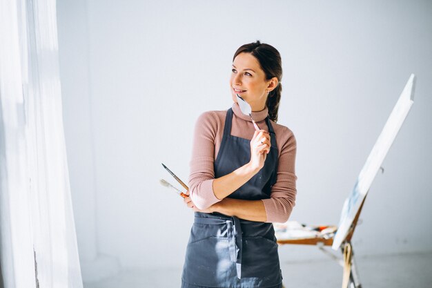 Female artist painting in studio