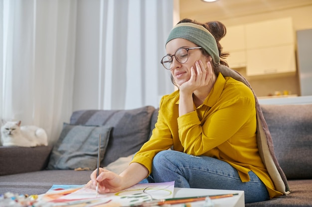 A female artist sitting in the studio with new sketches