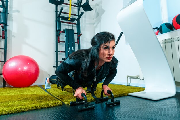 The female athlete doing they exercise in a ems fitness studio