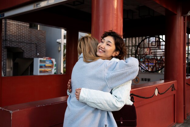 Female best friends hanging out together in town