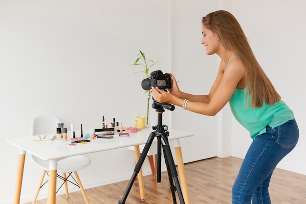 Free photo female blogger setting up camera